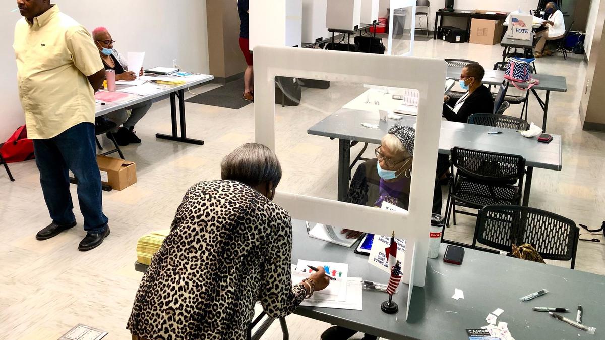 A voter checks in at the West Charlotte Community Center Precinct 25 on Senior Drive before voting on Tuesday, May 17, 2022.