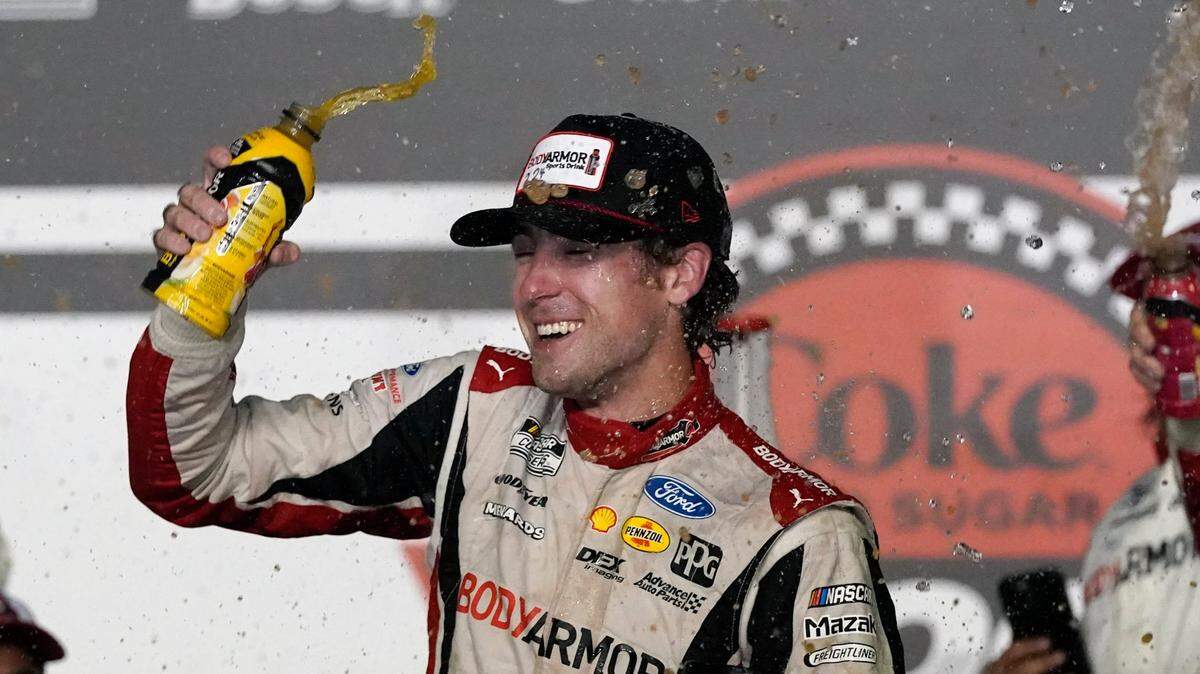Ryan Blaney celebrates in Victory Lane after winning the NASCAR Cup Series auto race at Daytona International Speedway, Saturday, Aug. 28, 2021, in Daytona Beach, Fla. (AP Photo/John Raoux)