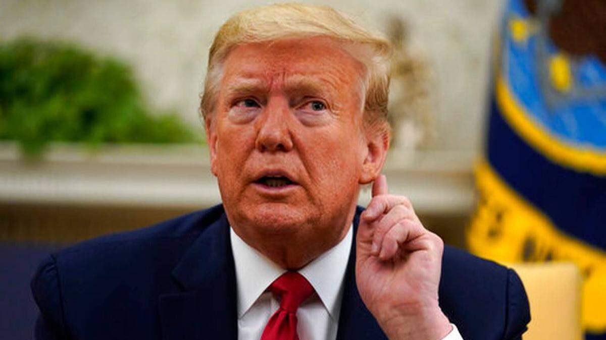 President Donald Trump listens to a reporter’s question Wednesday during a media briefing that followed an Oval Office meeting about coronavirus. Trump met with Louisiana Gov. John Bel Edwards. 