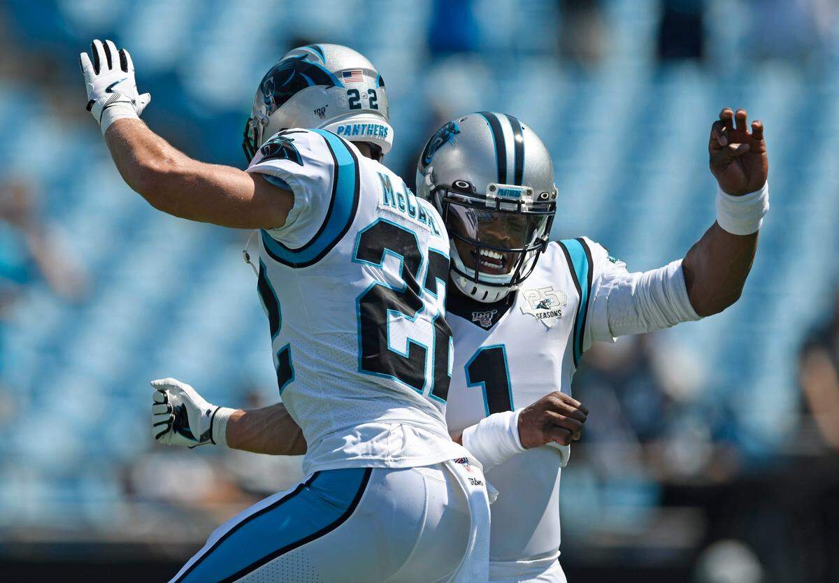 Carolina Panthers quarterback Cam Newton (1) jumps and greets running back Christian McCaffrey (22) on the field during pregame. McCaffrey would end up with 209 total yards and two touchdowns in Carolina’s 30-27 loss.