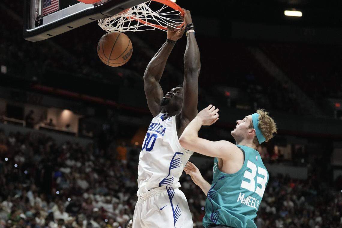 Philadelphia 76ers forward/center Adem Bona (30) dunks the ball against Charlotte Hornets forward Liam McNeeley (33) in the second quarter of their game at Thomas & Mack Center.