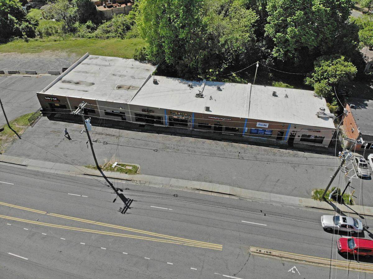 Traffic flows past a strip mall near the intersection of West Boulevard and Remount Road in Charlotte on Tuesday, April 27, 2021.