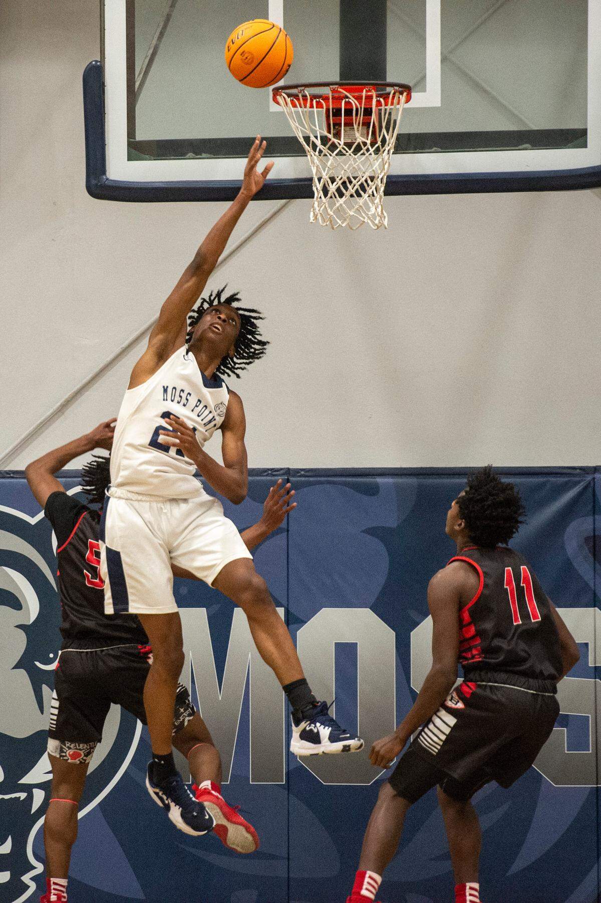 Moss Point forward Kedrick Osby scores during a game against Biloxi at Moss Point High School in Moss Point on Tuesday, Dec. 21, 2021.