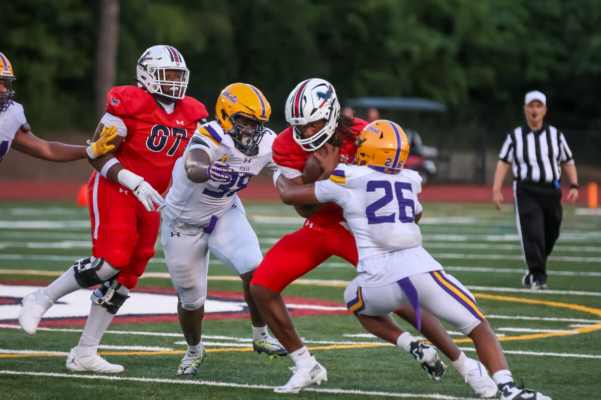 Providence Day QB Zaid Lott powers breaks tackles as he tries to score against Roman Catholic (PA) at Providence Day School in Charlotte, NC, on Friday, Aug. 22, 2025
