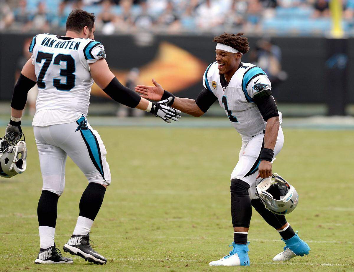 Carolina Panthers quarterback Cam Newton (right) reaches out to congratulate guard Greg Van Roten during the fourth quarter Sunday. Newton threw for two touchdowns and ran for two more in Carolina’s 31-21 win over Cincinnati.