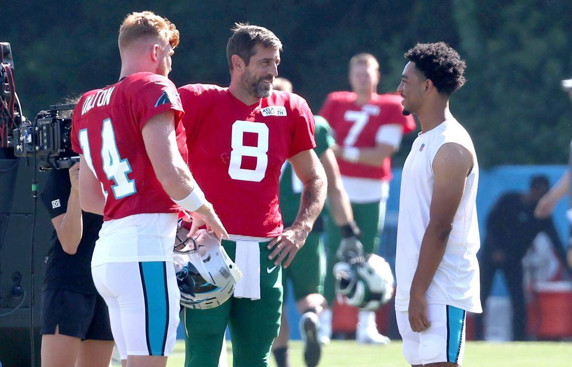 Carolina Panthers quarterbacks Andy Dalton, left, New York Jets quarterback Aaron Rodgers, center and Bryce Young, right, talk prior to the team’s joint practice at Wofford College in Spartanburg, SC on Wednesday, August 9, 2023.