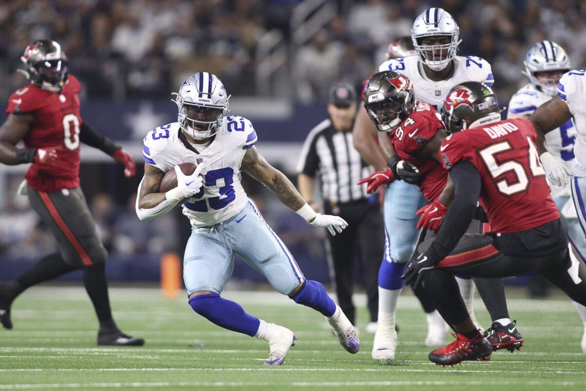 Dec 22, 2024; Arlington, Texas, USA; Dallas Cowboys running back Rico Dowdle (23) runs the ball against the Tampa Bay Buccaneers in the first half at AT&T Stadium. Mandatory Credit: Tim Heitman-Imagn Images