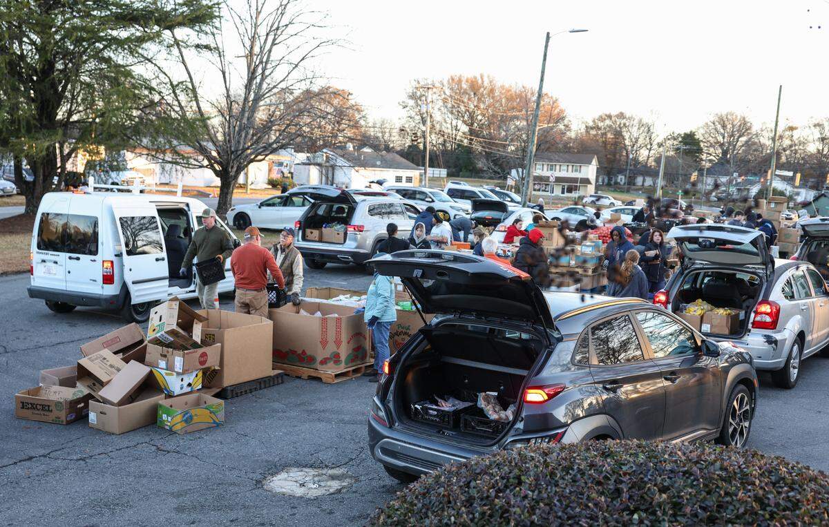Gastonia residents line up in their vehicles, trunks open and ready to receive food at Mount Zion Restoration Church last month.