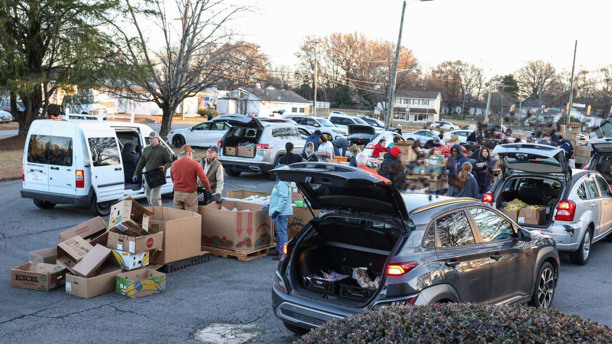 Gastonia residents line-up in their vehicles, trunks open and ready to receive food given out at Mount Zion Restoration Church on Crescent Lane on Thursday, December 19, 2024.