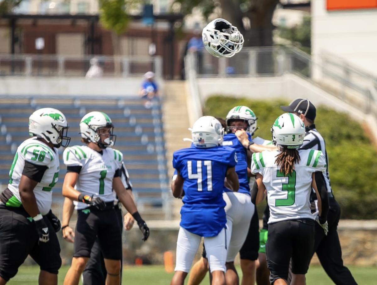 Helmets fly as a  brawl breaks out at midfield between Myers Park and Charlotte Christian