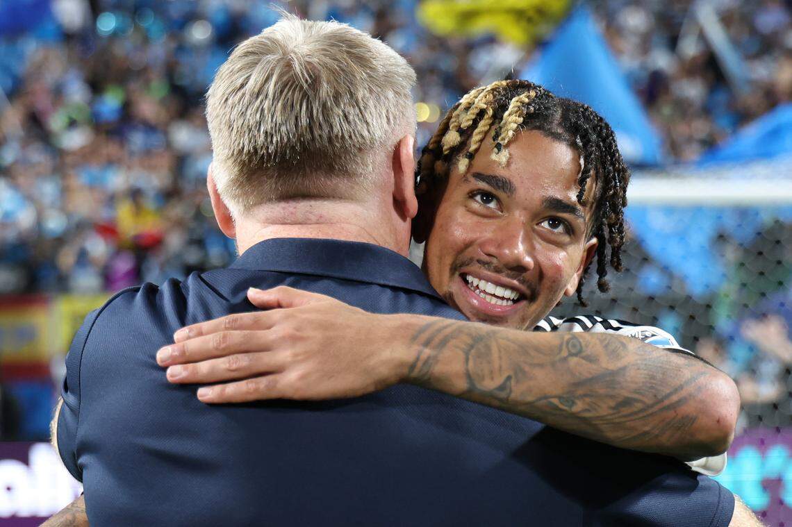 Idan Toklomati of Charlotte FC hugs coach Dean Smith after a Sept. 13, 2025, mmatch against Inter Miami CF at Bank of America Stadium.