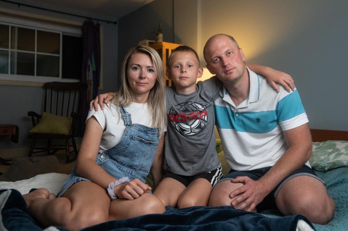 Olga Bludov, left, with her husband Ihor, right, and their 11-year-old son Misha, photographed in the room they’ve lived in in Marina Krcmar’s home since they arrived in Charlotte two months ago, following their escape from the war in Ukraine.