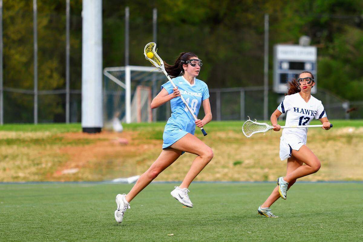 Charlotte Catholic lacrosse player Sophie Tan (left)