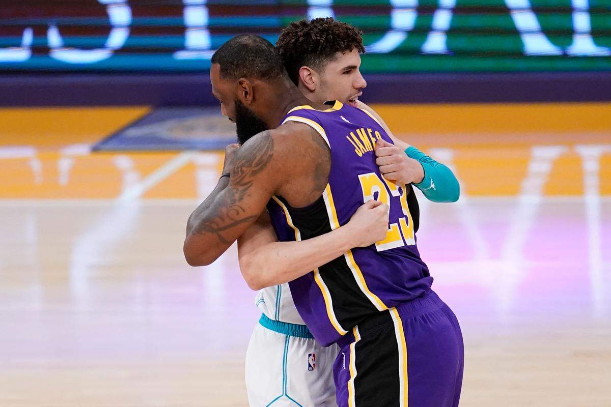 Charlotte Hornets guard LaMelo Ball and Los Angeles Lakers forward LeBron James (23) hug before an NBA game on March 18, 2021, in Los Angeles. James and the Lakers will visit Charlotte on Friday, Jan. 28, 2022.