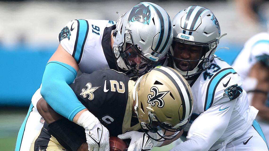 Carolina Panthers defensive end Morgan Fox, left and linebacker Haason Reddick, right, sack New Orleans Saints quarterback Jameis Winston during a game in Charlotte in September. Reddick has been placed on the COVID-19/Reserve list.