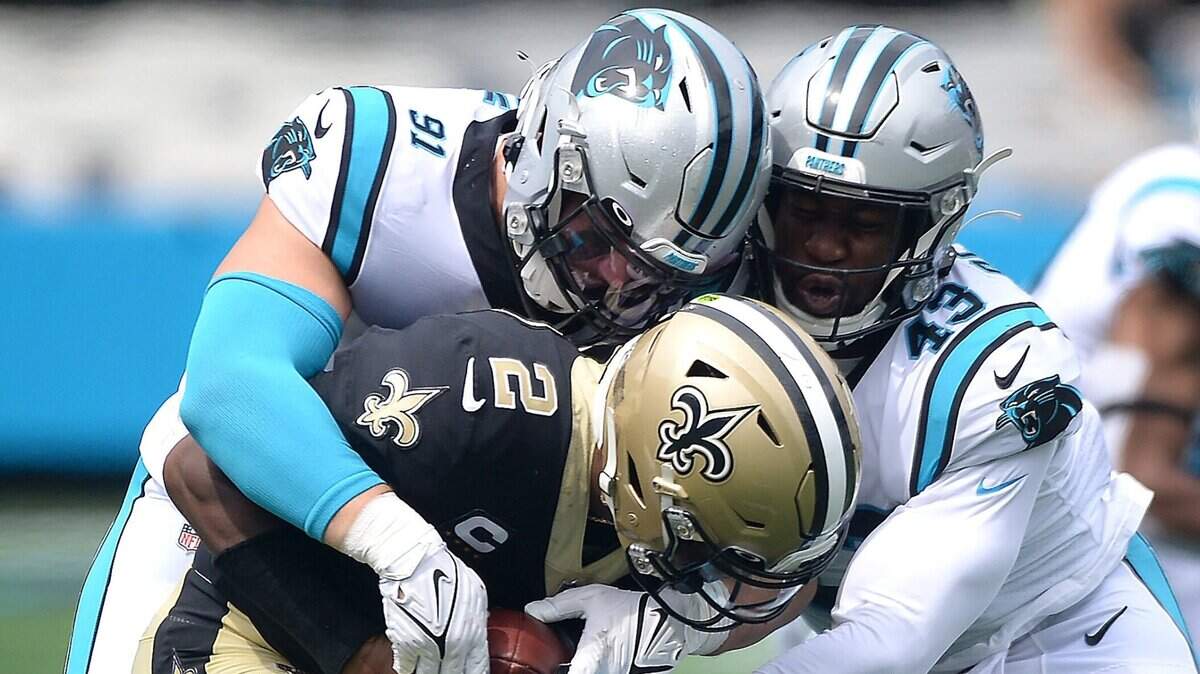 Carolina Panthers defensive end Morgan Fox, left and linebacker Haason Reddick, right, sack New Orleans Saints quarterback Jameis Winston during a game in Charlotte in September. Reddick has been placed on the COVID-19/Reserve list.