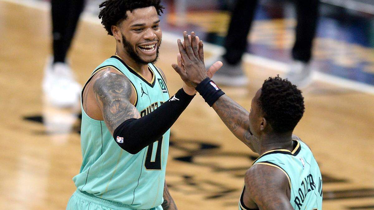 Charlotte Hornets forward Miles Bridges, left and guard Terry Rozier, right, celebrate the teamÕs play during first half action against the Boston Celtics at Spectrum Center in Charlotte, NC on Sunday, April 25, 2021.