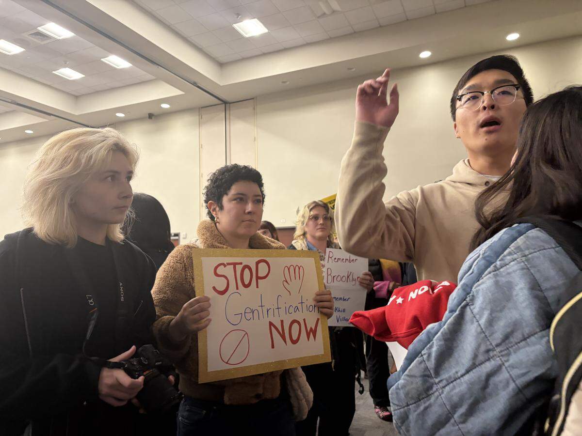 Participants shout “Let us speak!” at a town hall meeting discussing North Carolina Department of Transportation’s I-77 South Express Lanes project. The project would widen the highway and add toll lanes to an 11-mile stretch between the Brookshire Freeway exit to the South Carolina border.
