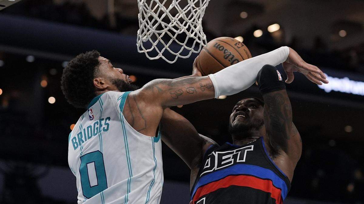 Detroit Pistons forward Paul Reed (7) is fouled by Charlotte Hornets forward Miles Bridges (0) at the rim during the second quarter at Spectrum Center.