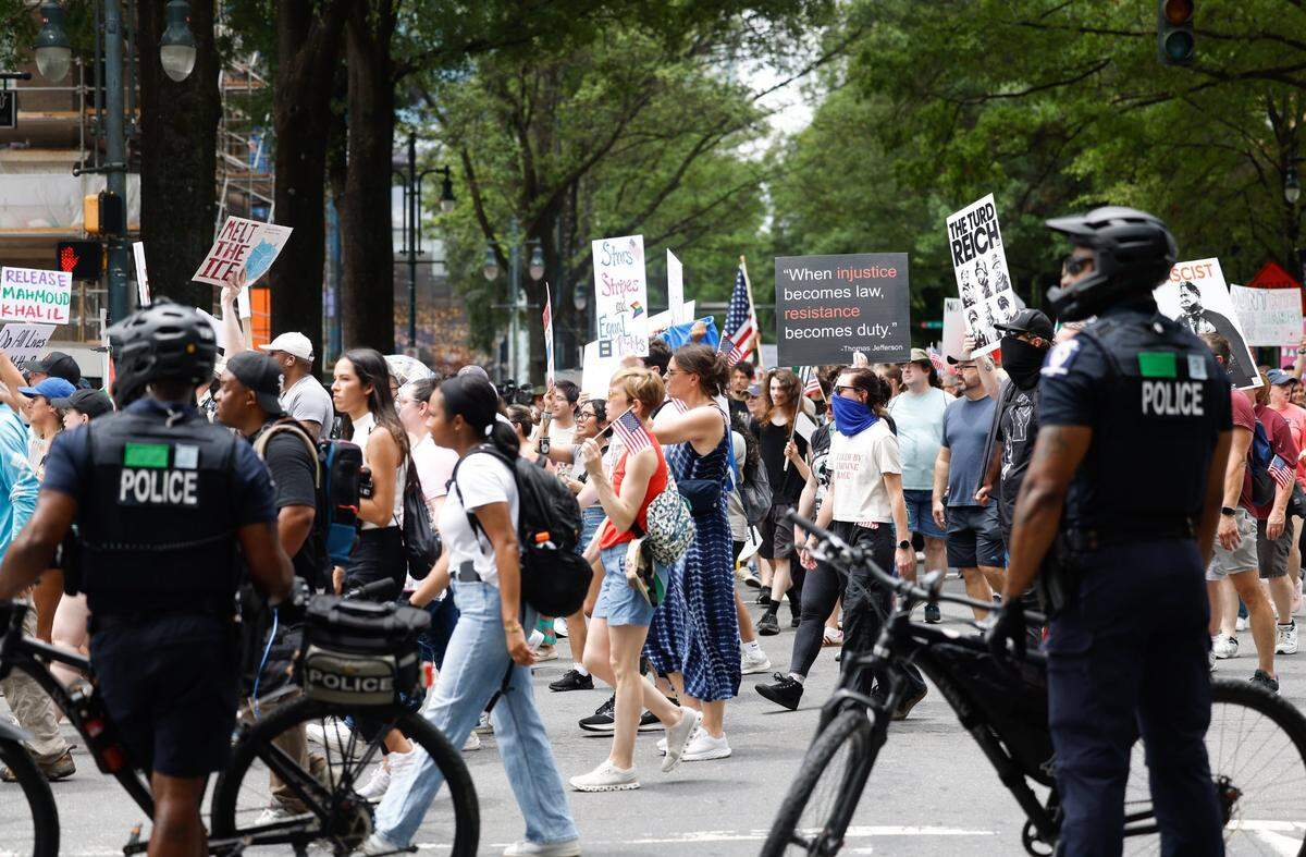 CMPD bike officers blocked traffic and watched protesters at the No Kings protest on North Tryon Street and 7th Street in Charlotte, Saturday, June 14, 2025. Over 5,000 people participated in the rally.
