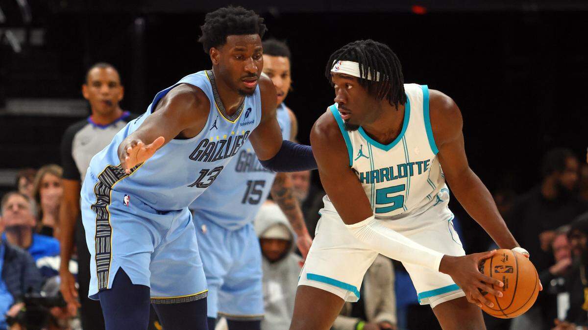 Charlotte Hornets center Mark Williams (5) handles the ball as Memphis Grizzlies forward Jaren Jackson Jr. (13) defends during Wednesday’s fourth quarter at FedExForum. Petre Thomas-Imagn Images