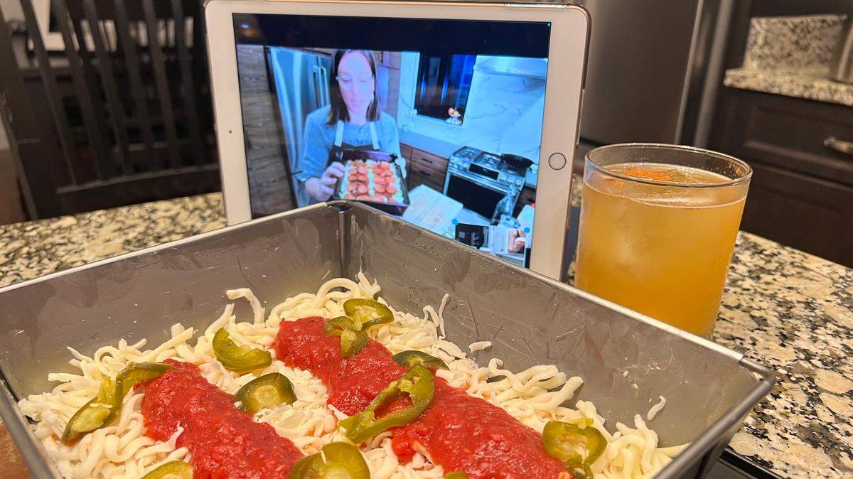 Emmy Squared co-founder Emily Hyland teaches virtual pizza and burger-making classes. Shown here is the Colony pizza (with red sauce, mozzarella, pepperoni, pickled jalapeños and honey. We skipped the pepperoni to make ours vegetarian). Hyland also teaches students to make one of the restaurant’s signature cocktails: Shown here is a Bobbing for Apple.