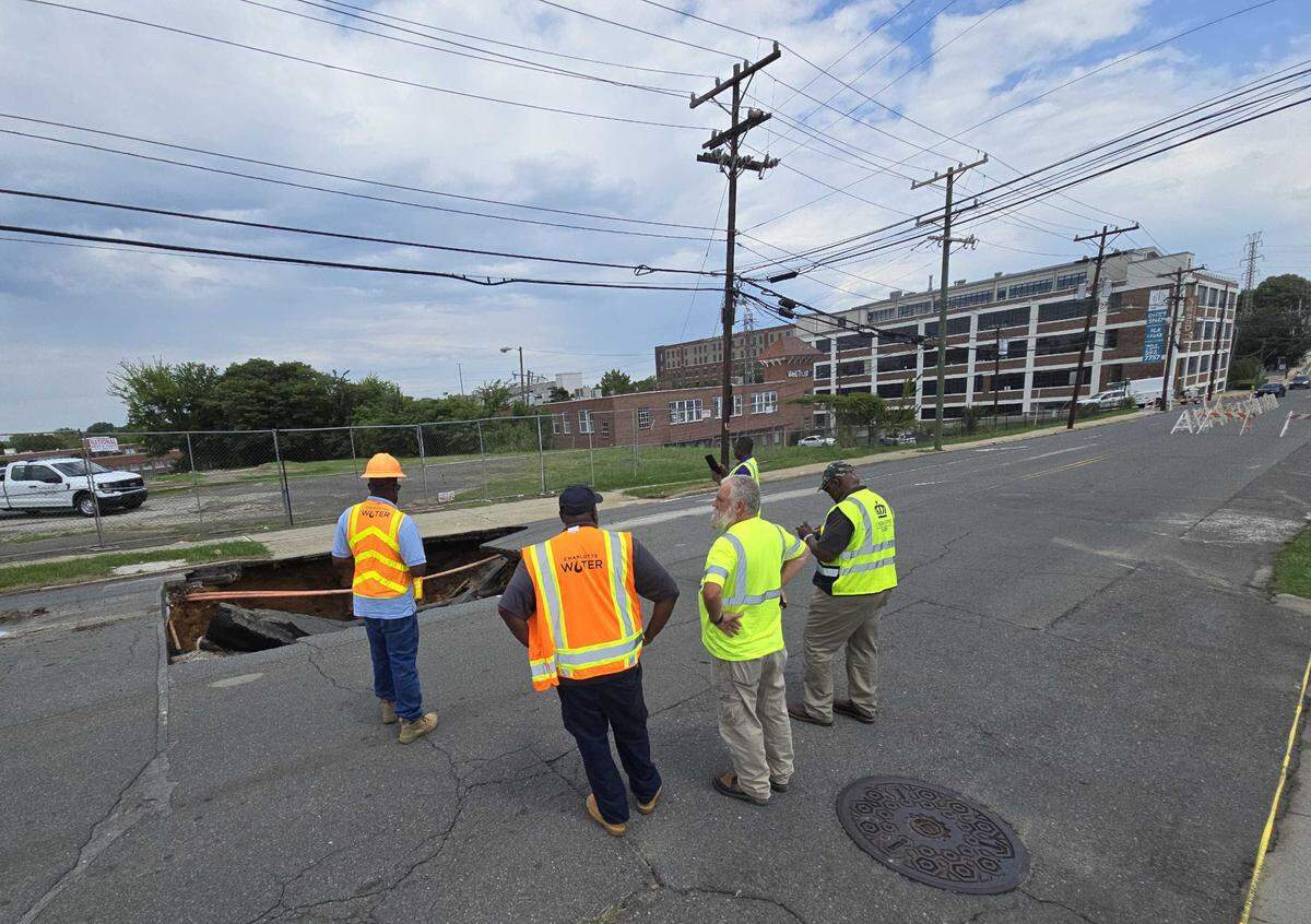 A massive sinkhole is seen on South Cedar Street near West Morehead Street in Charlotte on Tuesday, July 30, 2024. City leaders said a water leak is believed to be the cause.
