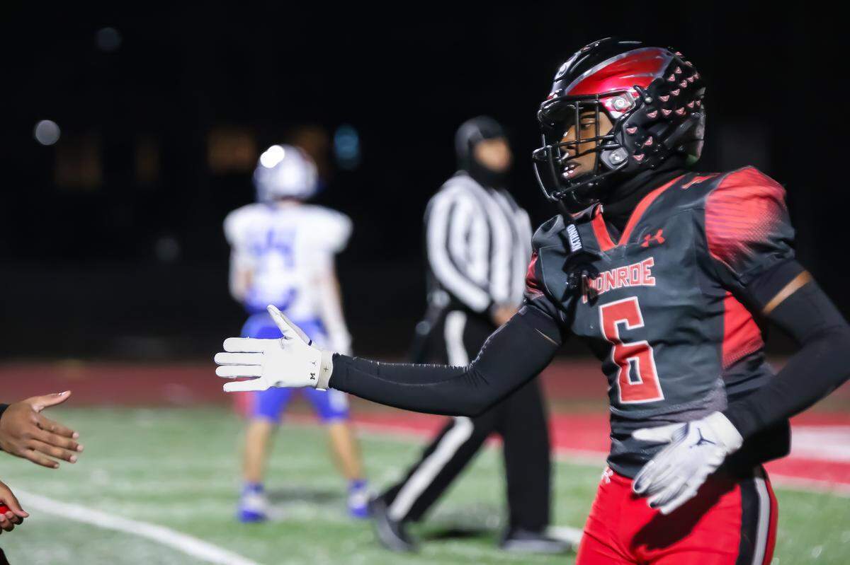 Monroe Jordan Young hi fives his teammate after scoring his second touchdown of the night at the NCHSAA 2A Western Regional championship game at Monroe high school in Monroe NC on Friday December 13th