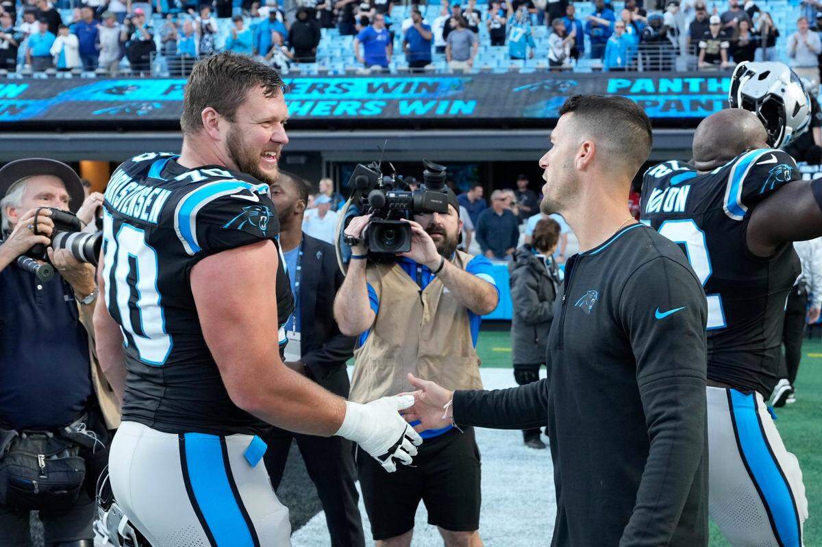 Nov 3, 2024; Charlotte, North Carolina, USA; Carolina Panthers guard Brady Christensen (70) with head coach Dave Canales after the game at Bank of America Stadium. Mandatory Credit: Bob Donnan-Imagn Images