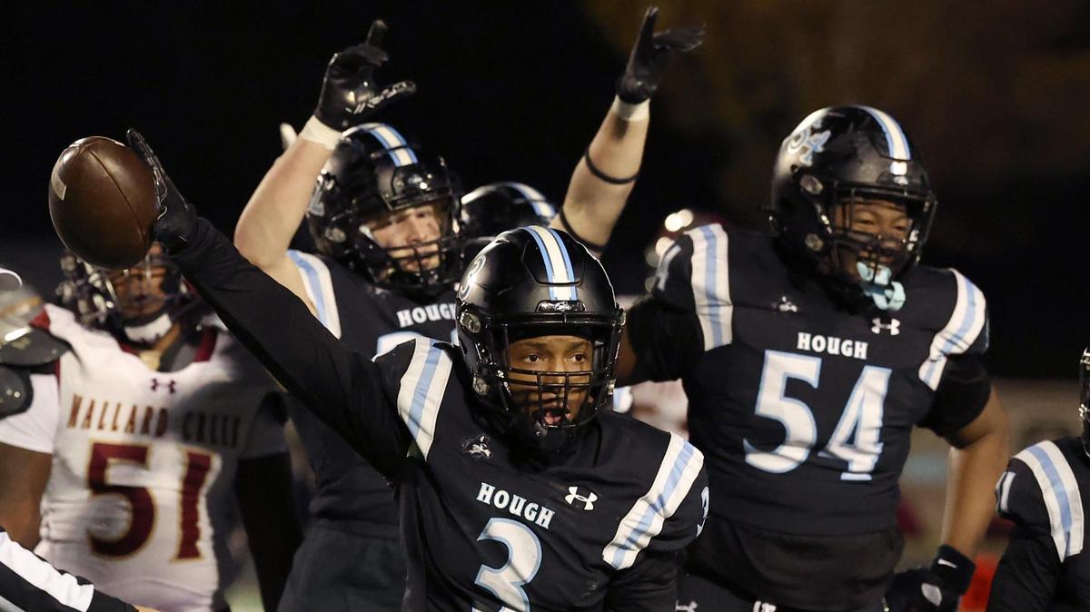 Hough Huskies defensive back Jackson Heath holds the ball out as he and his teammates celebrate his recovery of a fumble by the Mallard Creek Mavericks on Friday, November 29, 2024. The Huskies defeated the Mavericks 34-0 in third round NCHSAA playoff action at Hough High in Huntersville, NC.