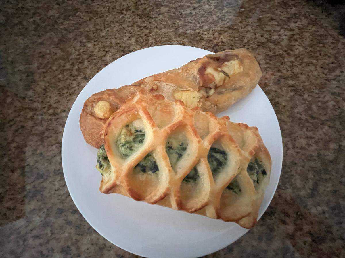A Swiss cheese sourdough bread with bacon, rosemary and onion and a savory croissant pastry from Mado Paris French Bakery & Cafe.