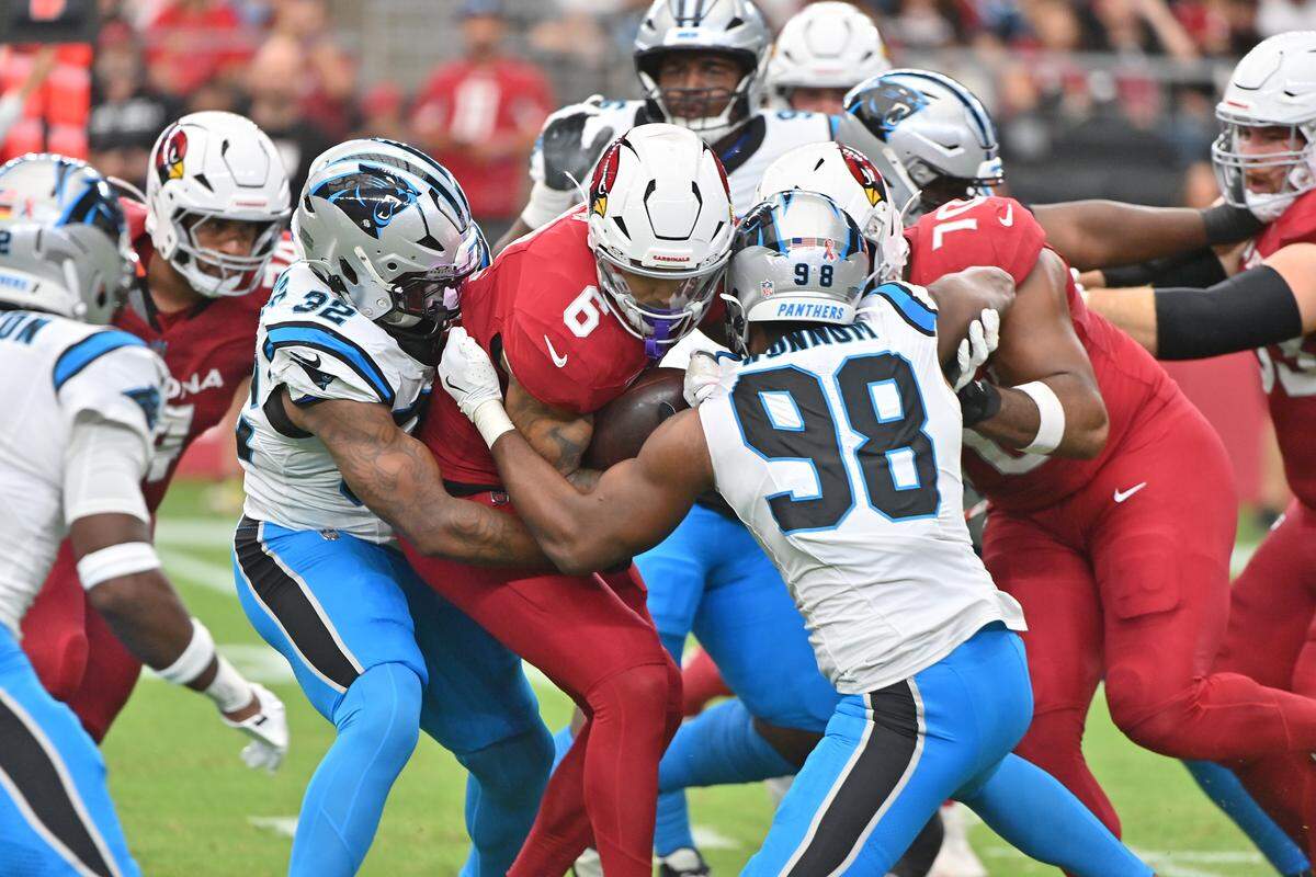 Arizona Cardinals running back James Conner (6) runs with the ball against Carolina Panthers linebacker D.J. Wonnum (98) during the second quarter at State Farm Stadium in Glendale, Ariz., on Sunday, Sept. 14, 2025.