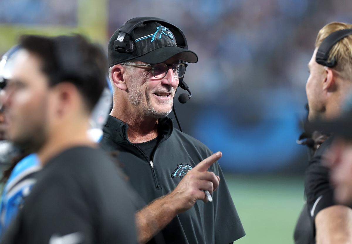Carolina Panthers head coach Frank Reich, left, speaks to quarterbacks coach Josh McCown, right, during second quarter against the Detroit Lions on Friday, August 25, 2023 at Bank of America Stadium in Charlotte, NC.