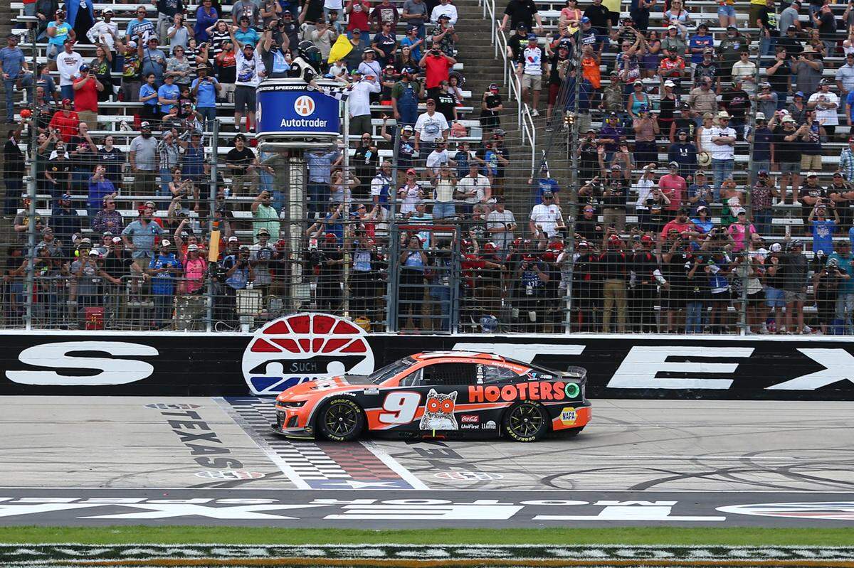 Apr 14, 2024; Fort Worth, Texas, USA; NASCAR Cup Series driver Chase Elliott (9) takes the checked flag, winning the NASCAR Cup Series AutoTrader EchoPark 400 at Texas Motor Speedway.