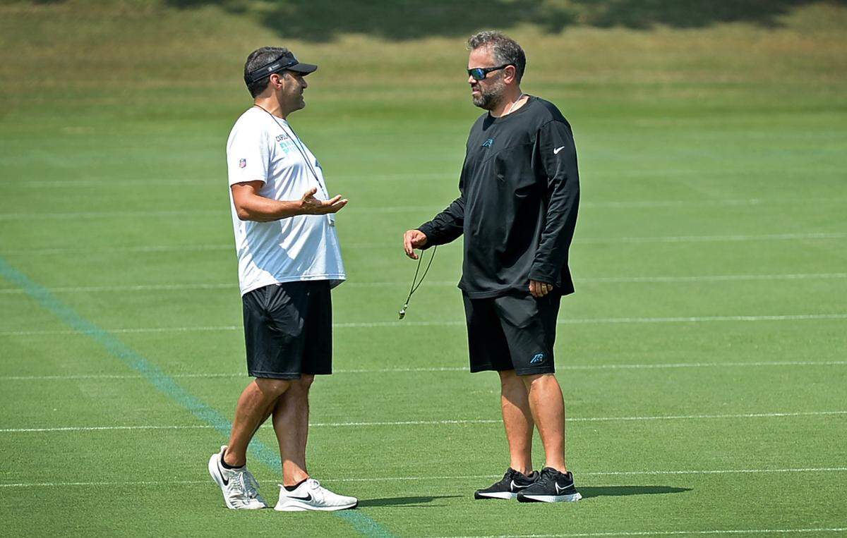 Carolina Panthers Director of Player Negotiations & Salary Cap Manager Samir Suleiman, left and head coach Matt Rhule, right, talk during practice on Wednesday, August 25, 2021.