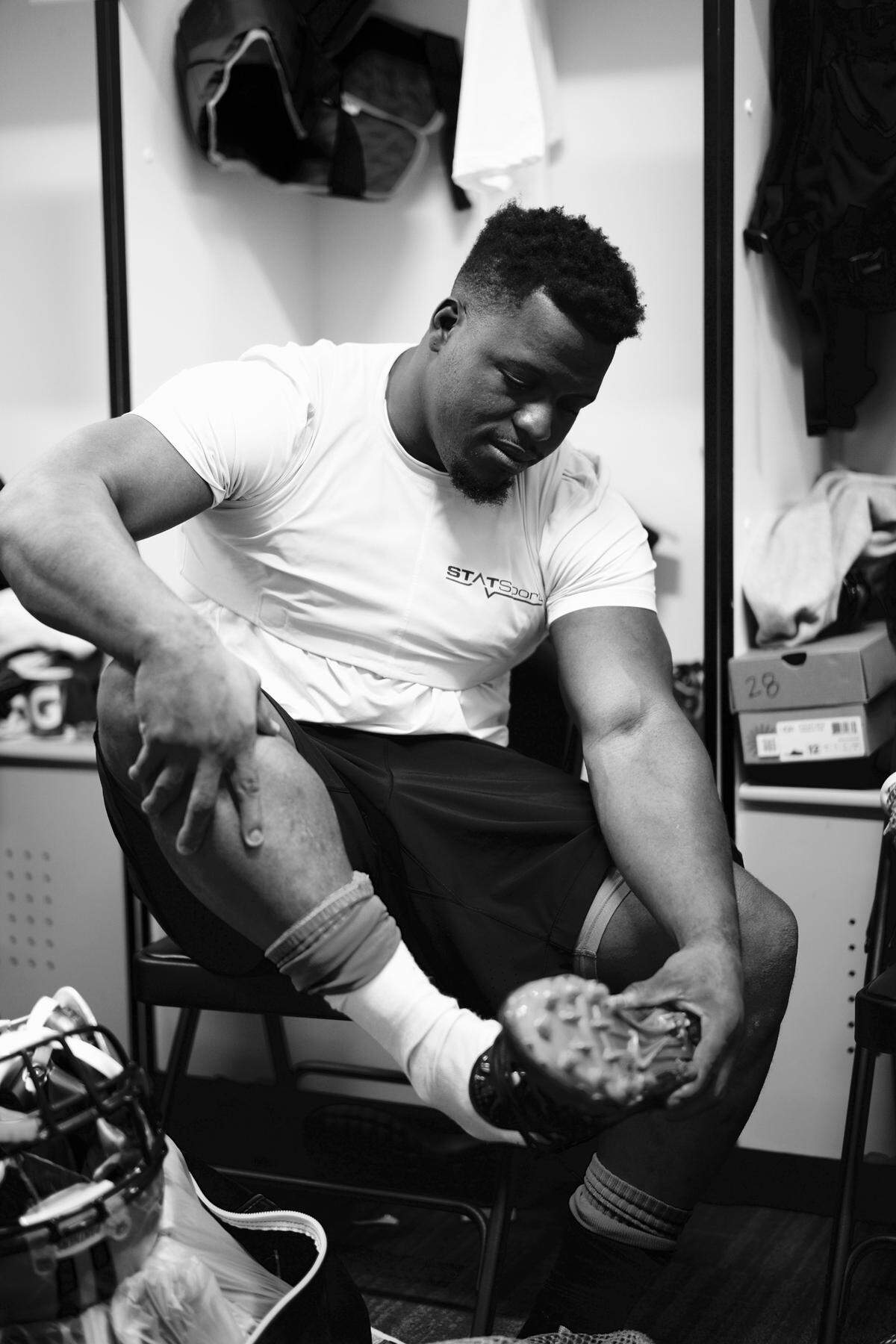 Carolina Panthers running back Jonathan Stewart adjusts his cleats in the locker room. “Stew,” as his teammates called him, was a bruising back who remains the Panthers’ all-time leading rusher and made the only Pro Bowl of his career in 2015.
