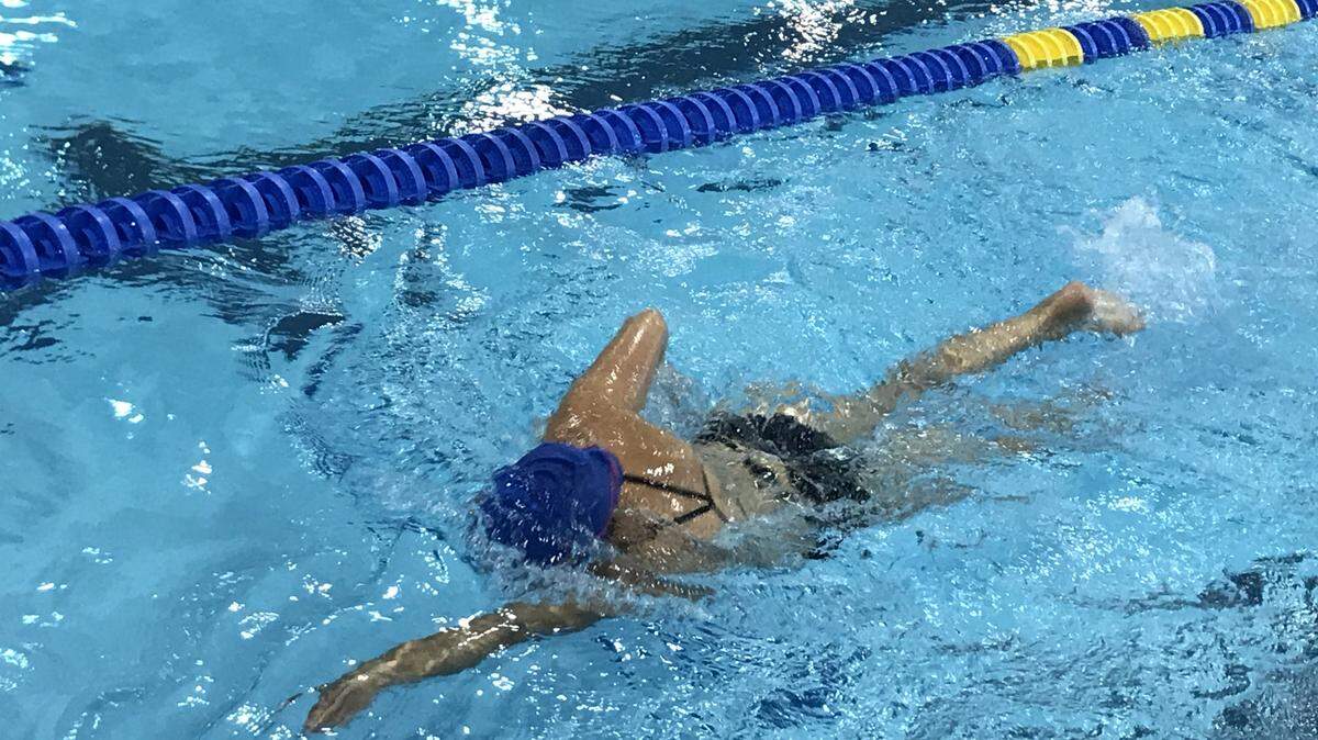Mecklenburg resident Julianna Jones swims freestyle at Mecklenburg County Aquatic Center. Daily rates at county indoor pools approximately doubled on Monday.