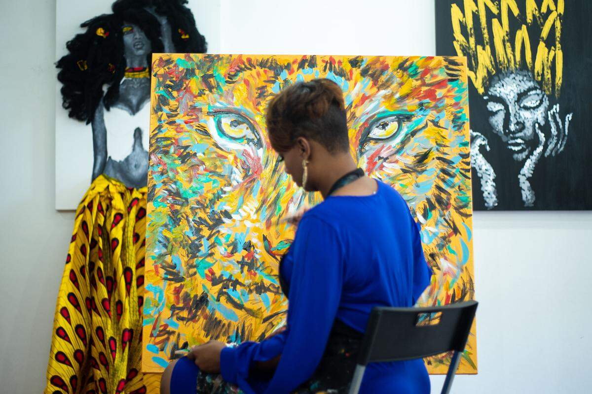 Whitney Austin works on a painting of a lion in her studio. She has quickly gained tens of thousands of followers on social media and is opening her third studio, this time at Carolina Place Mall.  It’s a workspace and a gallery where she’ll sell her original artwork and other items with prints of her artwork on them. 