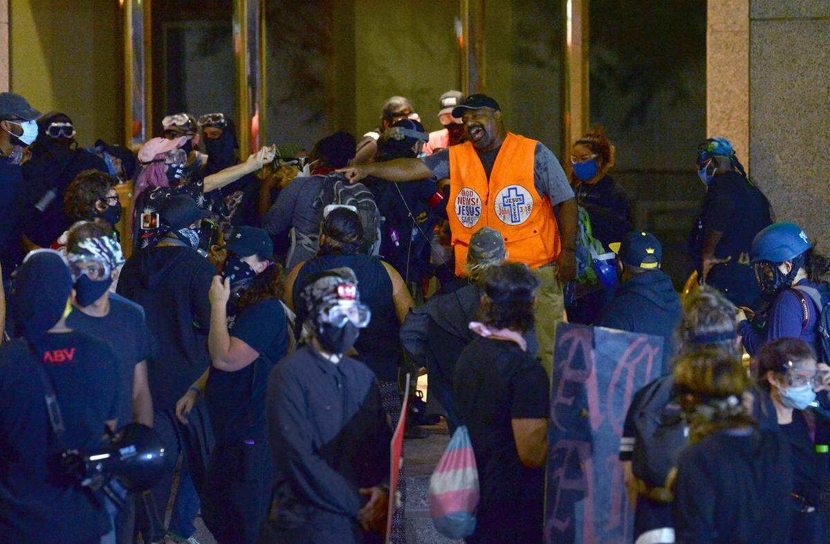 “I do not support Black Lives Matter, that organization, at all. Because, yeah, it’s anti-God,” says Sam Bethea, shown here mixing it up with protesters along College Street in uptown Charlotte on Aug. 22. “To me, all life matters.”