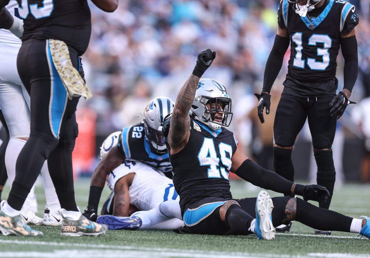 Carolina Panthers linebacker Frankie Luvu raises a fist in the air after tackling Indianapolis Colts wide receiver Josh Downs at the Bank of America Stadium in Charlotte, N.C., on Sunday, November 5, 2023.