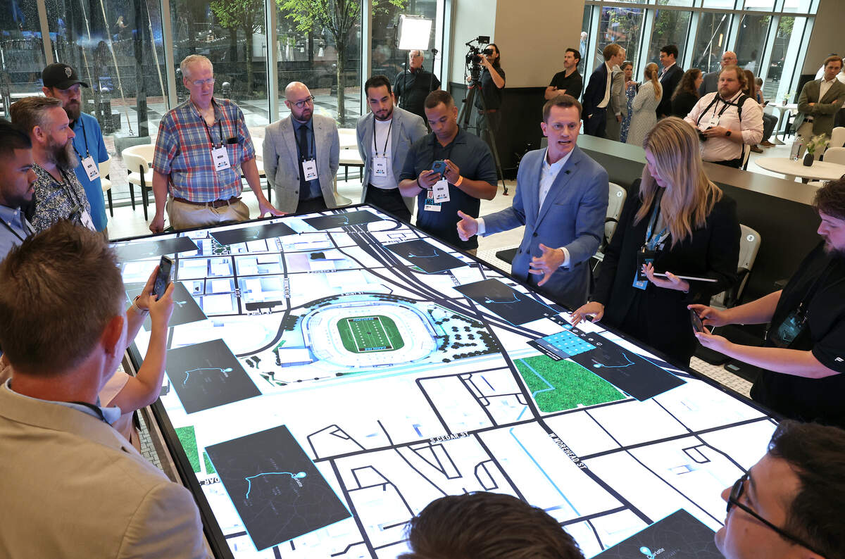 Eric Sudol, Chief Revenue Officer at Tepper Sports and Entertainment explains The Table to media members during a tour of Momintum an experience center in uptown Charlotte, NC that allows potential customers to see what will be available at a fully renovated Bank of America Stadium on Thursday, July 23, 2026. The Table helps PSL owners visualize NFL game days giving tips on how to get in and out of the stadium, traffic patterns and other information.
