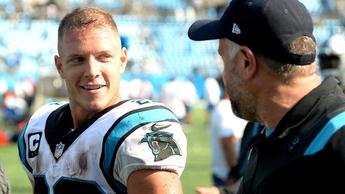 Carolina Panthers running back Christian McCaffrey, left and head coach Matt Rhule, right, enjoy the walk to the teamÕs locker room following the teamÕs 19-14 victory over the New York Jets at Bank of America Stadium in Charlotte, NC on Sunday, September 12, 2021.