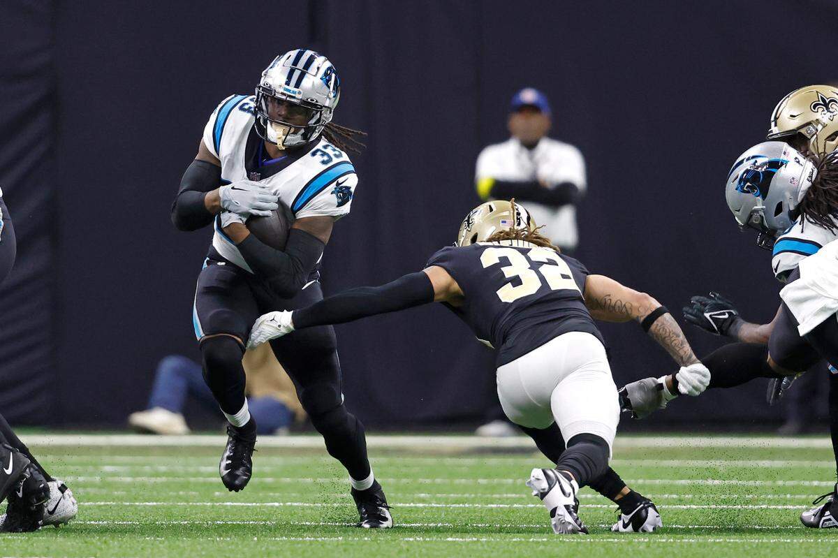 Carolina Panthers running back D’Onta Foreman (33) runs the ball past New Orleans Saints safety Tyrann Mathieu (32) during an NFL football game, Sunday, Jan. 8, 2023, in New Orleans. (AP Photo/Tyler Kaufman)