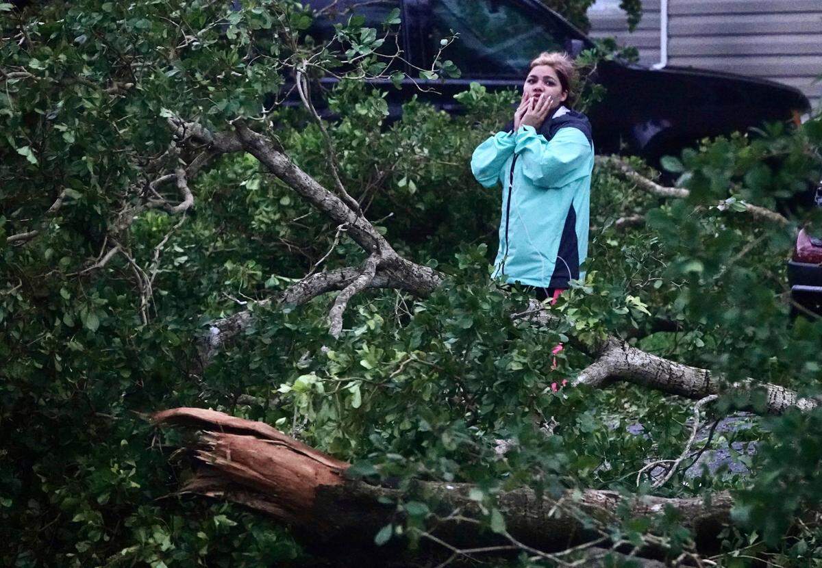 Zuram Rodriguez surveys the damage around her mobile home in Davie, Fla., early Wednesday, Sept. 28, 2022. Hurricane Ian rapidly intensified off Florida’s southwest coast Wednesday morning, gaining top winds of 155 mph (250 kph), just shy of the most dangerous Category 5 status..