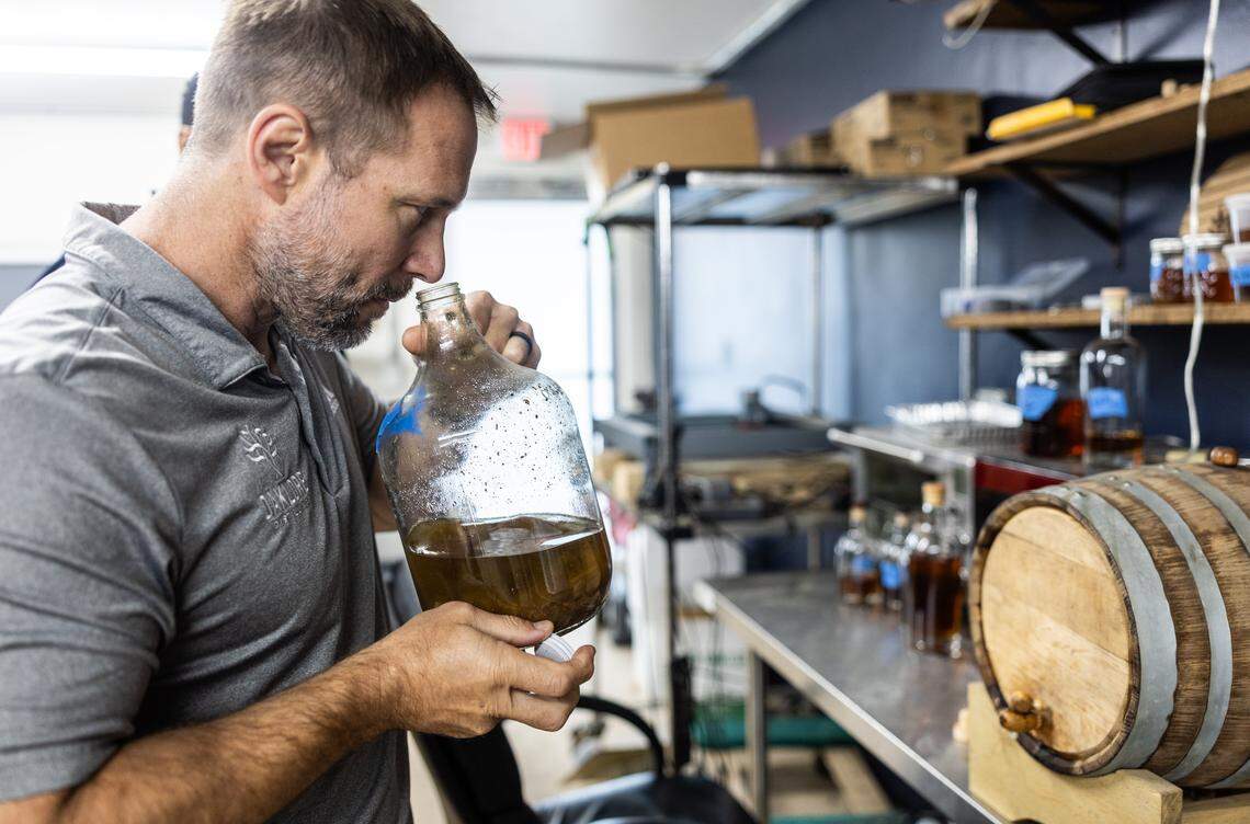 Tom Bogan smells a rhubarb bitters he's making at Oaklore Distilling Co. in Matthews, N.C., on Tuesday, Sept. 30.