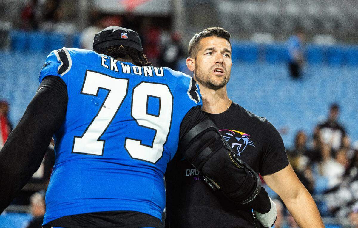 Carolina Panthers coach Dave Canales, right, embraces Carolina Panthers offensive tackle Ikem Ekwonu after a loss against the Atlanta Falcons at the Bank of America Stadium in Charlotte, N.C. on Sunday, October 13, 2024.