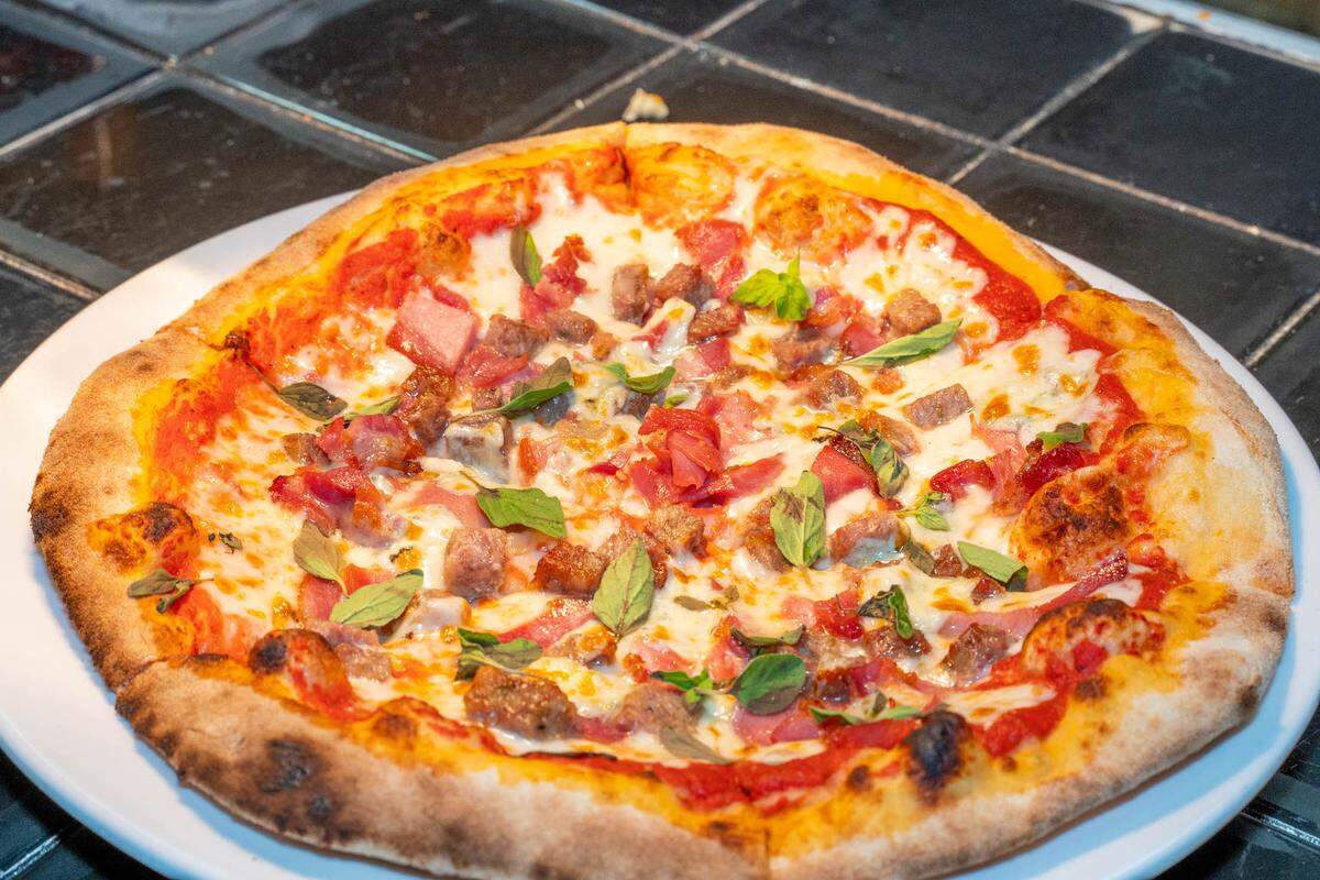 The Bronx Bomber is Brixx’s signature pizza, featuring spicy Italian sausage, prosciutto, mozzarella and gorgonzola on tomato sauce and topped with fresh oregano.