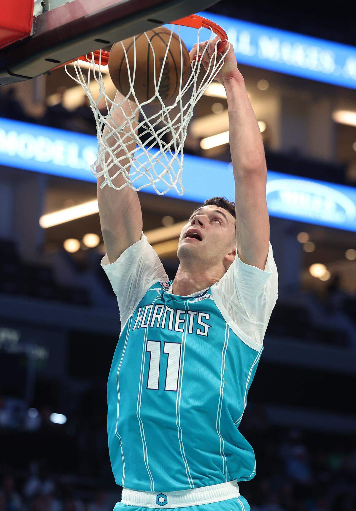 Charlotte Hornets center Ryan Kalkbrenner throws down a two-handed dunk during action against the Brooklyn Nets on Wednesday at Spectrum Center.