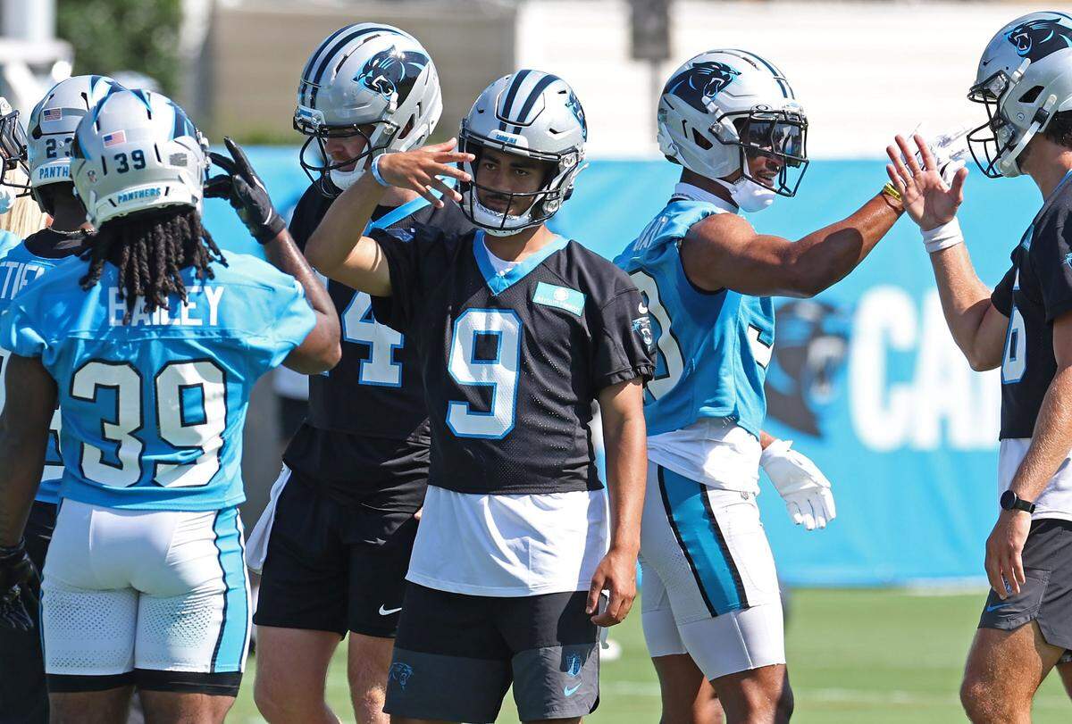 Carolina Panthers running back Emani Bailey, left and quarterback Bryce Young, right, greet one another following a series of drills during a training camp practice on Wednesday, July 23, 2025. 