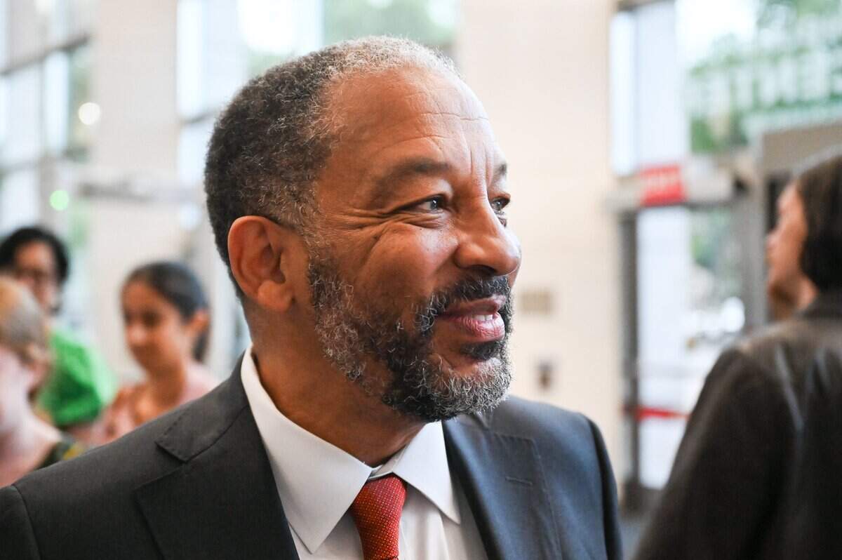 Robert Harrington, left, smiles after receiving the majority of votes needed to become interim mayor after acting mayor, Vi Lyles, steps down at the end of June.